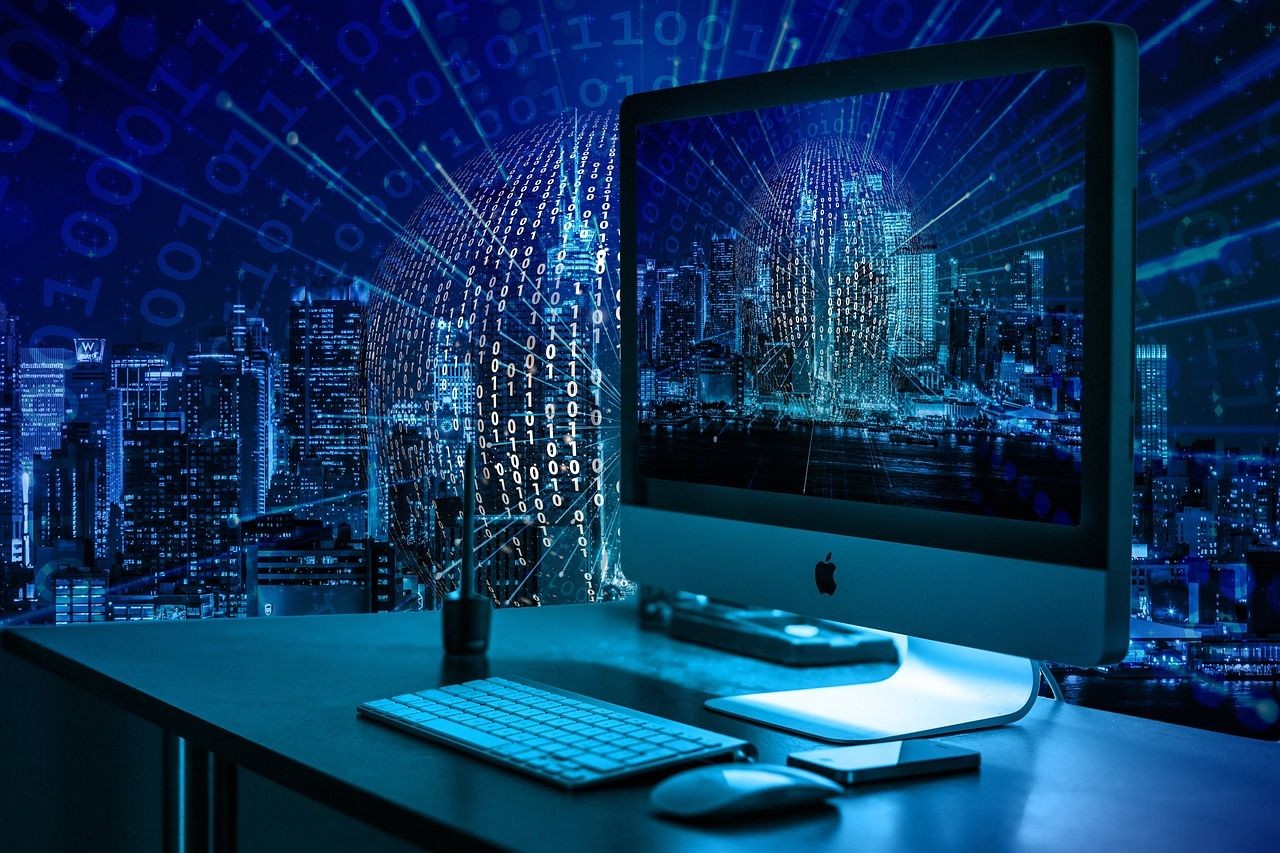 Digital composite image of a computer on a desk with binary code overlay and a cityscape background.
